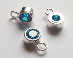  ** NEW LOWER PRICE ** sterling silver, stamped 925, 8.35mm x 5.15mm drop / charm containing a 4mm aqua blue cubic zironia, very nicely made, has closed jumpring attached at the top with internal diameter of 1.5mm 
