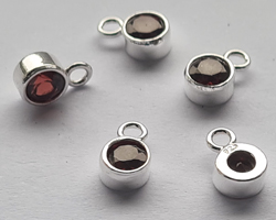  ** NEW LOWER PRICE ** sterling silver, stamped 925, 8.35mm x 5.15mm drop / charm containing a 4mm garnet cubic zironia, very nicely made, has closed jumpring attached at the top with internal diameter of 1.5mm 